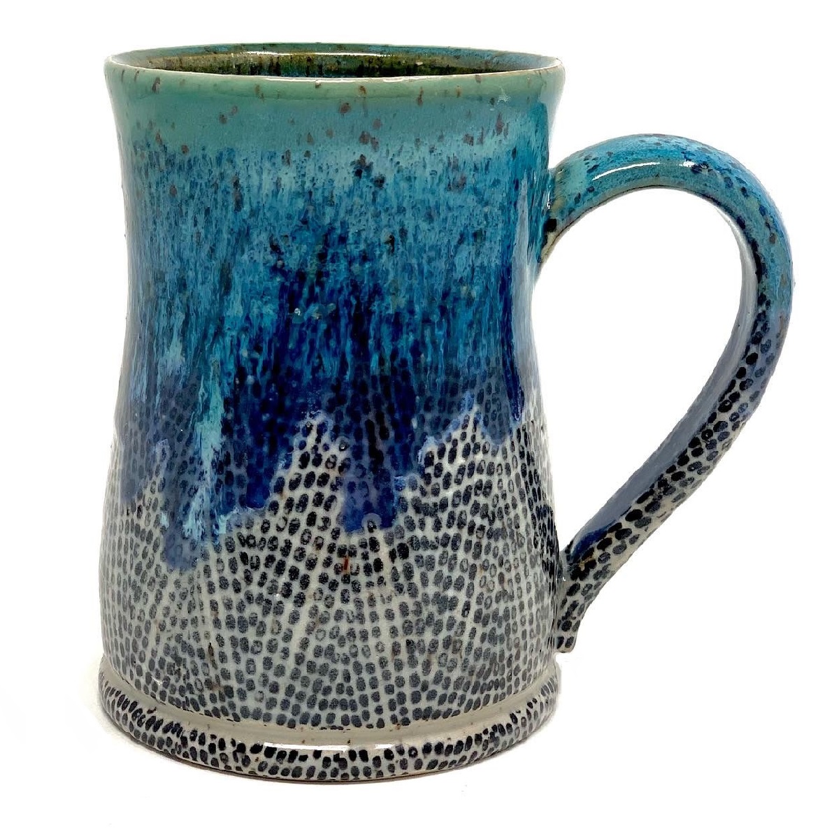 The Indigo Mug offers a robust tactile experience with its dynamic blue glaze that flows like an Appalachian waterfall over a pebbled riverbed.