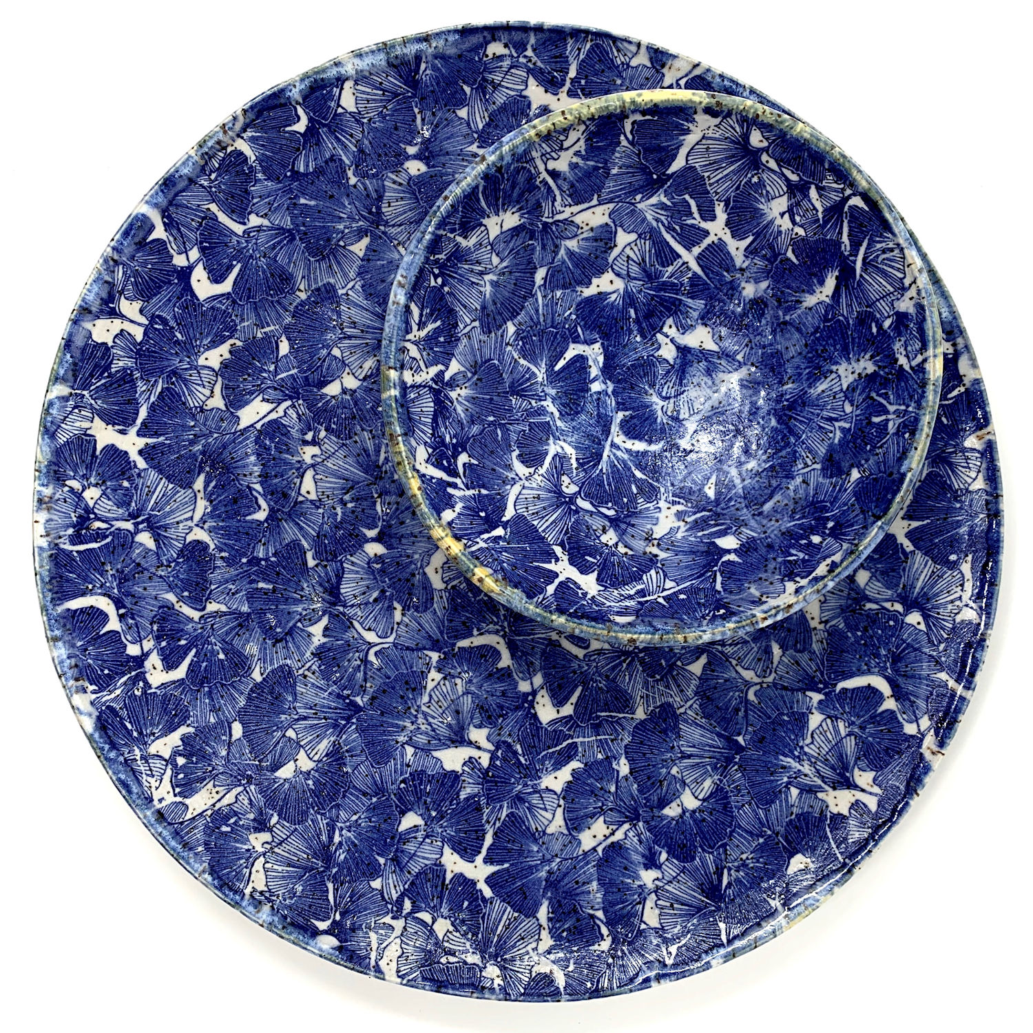 This chip n' dip cover features a vibrant blue botanical print, rich in detail, evoking a sense of a lush garden in full bloom. The bold pattern contrasts beautifully against the white background, making it both a functional serving piece and a statement artwork for any gathering.