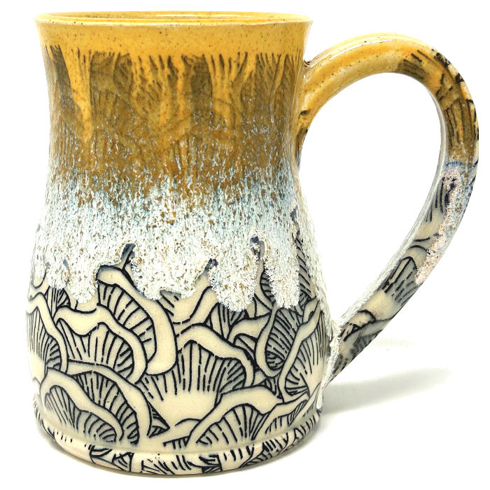The Mushroom Mug is a handcrafted gem that’s perfect for your morning brew or evening tea. You’ll be reminded of fall poplars as the golden-yellow glaze gives way to an Indigo signature mushroom motif.