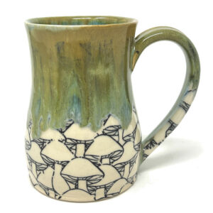 The Mossy Mushroom Mug. The mossy green glaze that drips from the rim is reminiscent of a forest carpet, making it a vessel that brings the essence of nature to your table